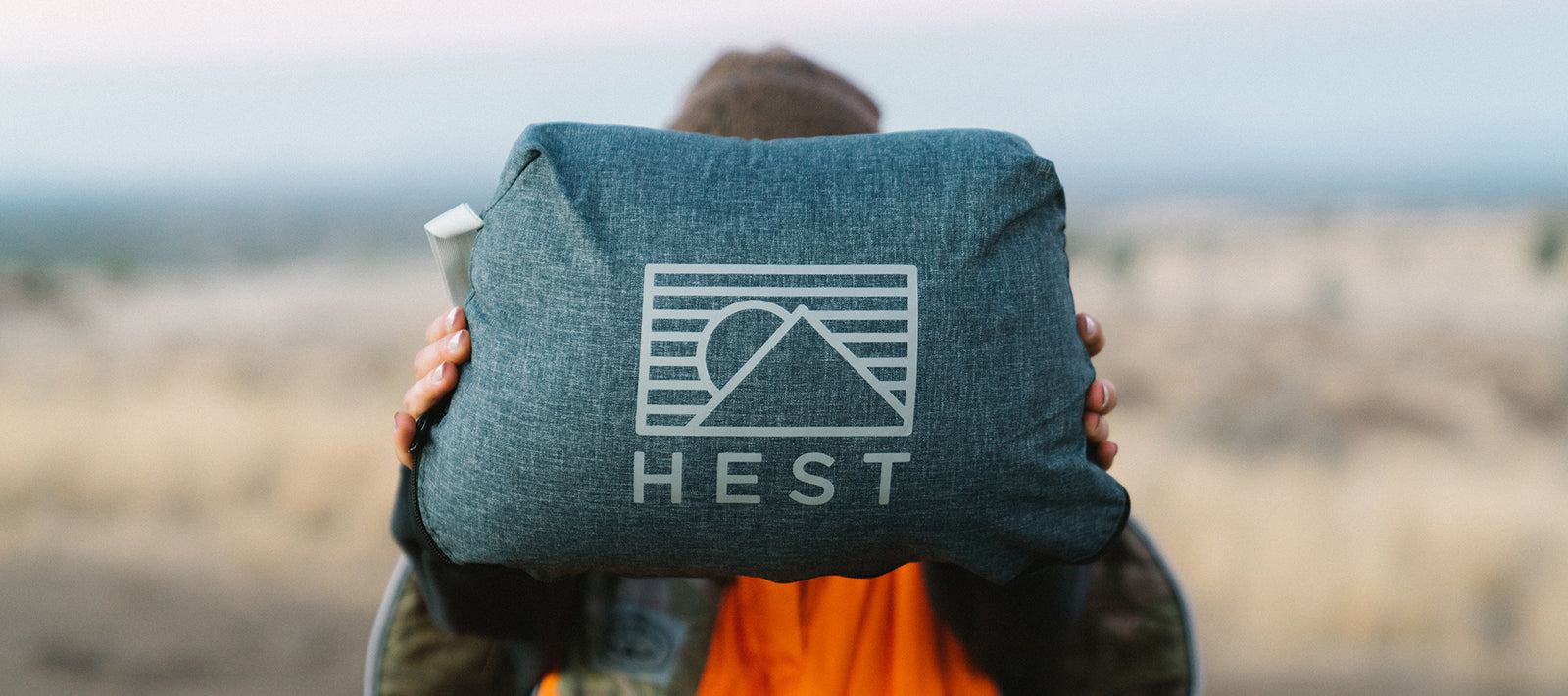 lady hold up to the camera the best camping pillow